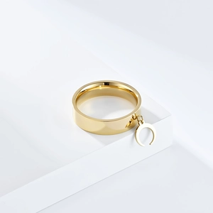 Polished gold stainless steel ring featuring a minimalist crescent moon charm detail