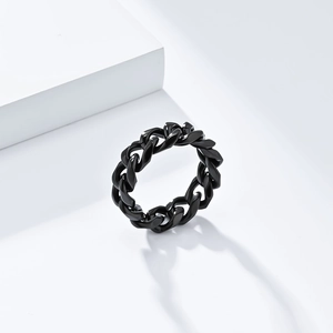 Detailed view of matte black Cuban link chain ring with industrial style on white stand