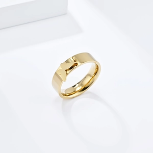 Polished gold wide band ring with a 3D butterfly centerpiece on a geometric pedestal