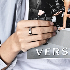 6mm silver stainless steel wide band ring with hollow LOVE lettering on a model