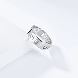 Detailed macro view of the silver hollow LOVE engraved stainless steel minimalist ring