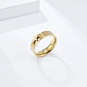 Minimalist gold stainless steel ring with a small hanging cross charm detail