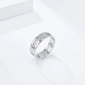 Macro view of hollow out LOVE lettering on a minimalist silver stainless steel ring band