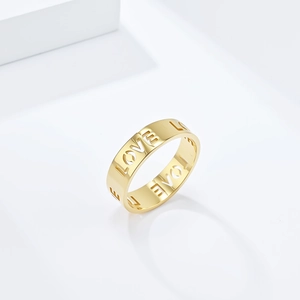 Macro view of gold stainless steel wide ring band with hollowed out LOVE letter design