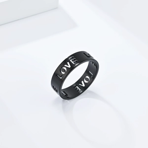 Macro shot of matte black stainless steel band with hollowed-out LOVE letter engraving