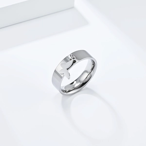 Polished stainless steel ring band featuring a delicate hanging butterfly charm