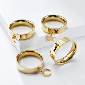 Set of four gold stainless steel rings featuring cross star butterfly and moon charms