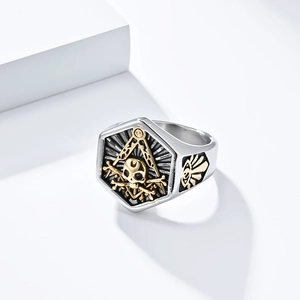 Macro shot of Freemason G symbol and skull patterns on vintage stainless steel ring