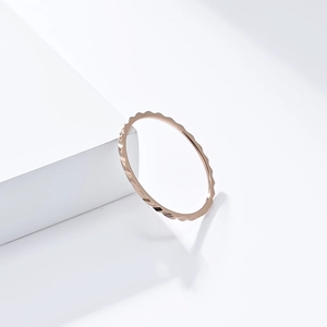 Dettaglio macro di un anello da 1mm in oro rosa con trama a onde per layering