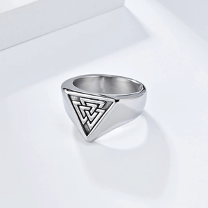 Macro detail of silver Valknut ring featuring engraved Nordic symbols and oxidized finish