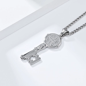Close-up of Saint Benedict Medal key pendant with hollow cross and Cuban chain