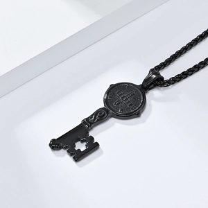 Detailed macro of black stainless steel St. Benedict key pendant with cross cutout