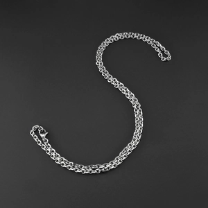 Detailed view of silver O-style cable chain with secure lobster clasp on grey surface