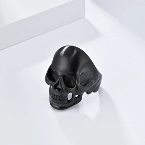 Macro detail of matte black skull ring with retro brushed finish and gothic punk design