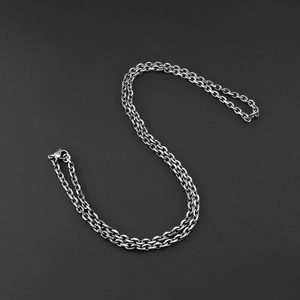 Detail view of unisex antique silver stainless steel O-chain necklace on black background