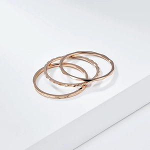 Ensemble de trois bagues empilables de 1mm en titane rose gold avec textures variées