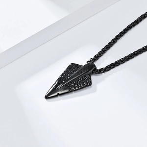 Macro shot of black Viking rune arrow pendant with vintage Nordic engraving details