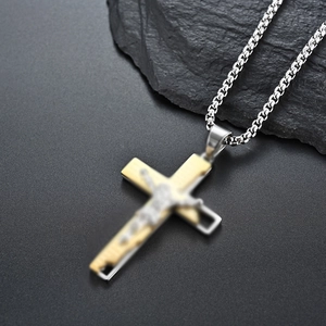 Detail of silver chain with dual-layer gold and silver crucifix pendant for men