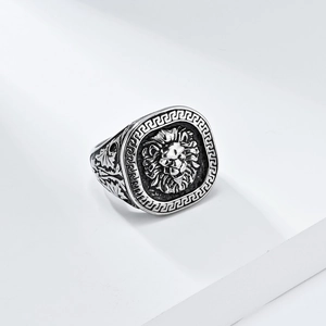 Macro detail of retro lion head relief with Greek meander pattern on men's stainless steel ring