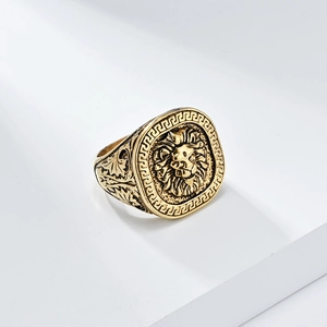 Vintage gold lion head signet ring with Greek key pattern border and engraved band details