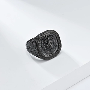 Detail of a vintage black lion head signet ring with meander border and leaf carvings
