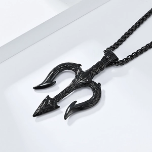 Macro detail of matte black stainless steel Poseidon trident pendant with vintage patterns