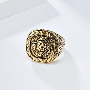 Detailed view of antique gold lion head signet ring with Greek meander pattern and engraving