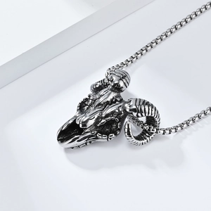 Close-up of gothic ram skull pendant with realistic horn textures on a box chain