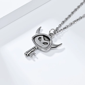 Macro detail of gothic stainless steel little devil key pendant with polished silver finish