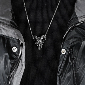 Retro stainless steel goat skull necklace with vintage horns worn on a black sweater
