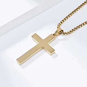 Macro side view of mirror-polished gold cross pendant on a durable round box chain