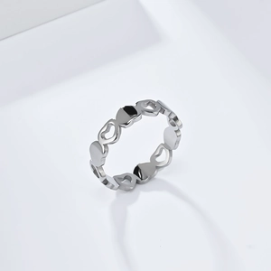 Macro detail of silver heart shaped hollow ring with polished stainless steel surface