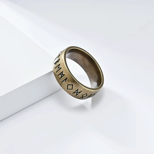 Macro shot of Viking runes engraved on a vintage bronze finish stainless steel ring