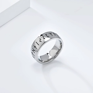 Macro shot of silver stainless steel ring featuring engraved Nordic Elder Futhark runes