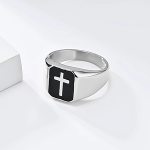 Polished stainless steel signet ring with black enamel and silver cross on white background