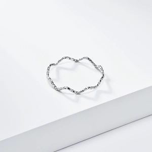 Detailed close-up of a 1mm silver wavy textured ring with reflective diamond-cut finish