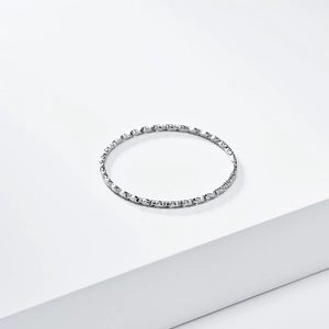 Macro shot of minimalist silver stackable ring with shimmering textured finish details