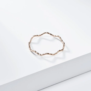 Detailed close-up of 1mm rose gold wave ring with textured hammered finish for women