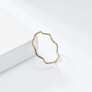 Detailed macro view of 1mm golden wavy ring with hammered texture for elegant styling