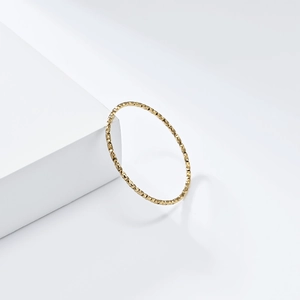 Minimalist 18K gold plated titanium steel ring with textured surface on white blocks