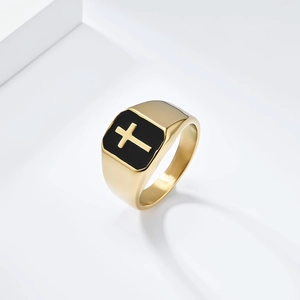 Detail of a gold signet ring for men with a black enamel square face and cross motif