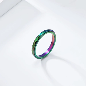 Rainbow geometric spinning ring in stainless steel with a faceted diamond-shaped surface