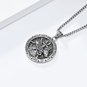 Detail of silver stainless steel Ankh cross and Anubis relief on round pendant