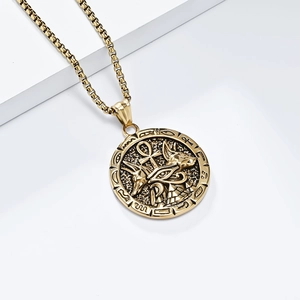 Golden Ankh Cross and Anubis Egyptian medallion necklace on white tiered display
