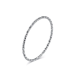 Minimalist silver geometric carved stackable ring with shimmering textured facets