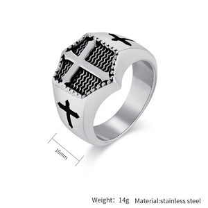 Macro shot of silver stainless steel signet ring with embossed cross and wave texture