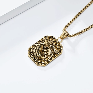 Macro detail of golden dragon head relief on vintage stainless steel pendant necklace