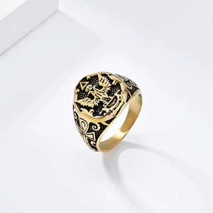 Close-up of vintage eagle relief and Ankh symbol on golden stainless steel signet ring
