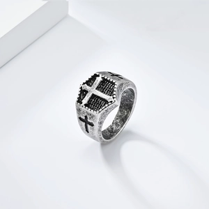 Detailed close-up of a vintage shield-shaped cross ring with oxidized silver finish details