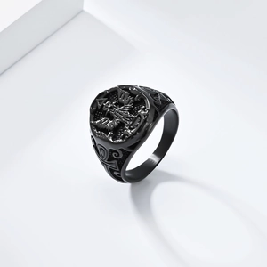 Macro shot of black stainless steel seal ring with double-headed eagle and Ankh cross